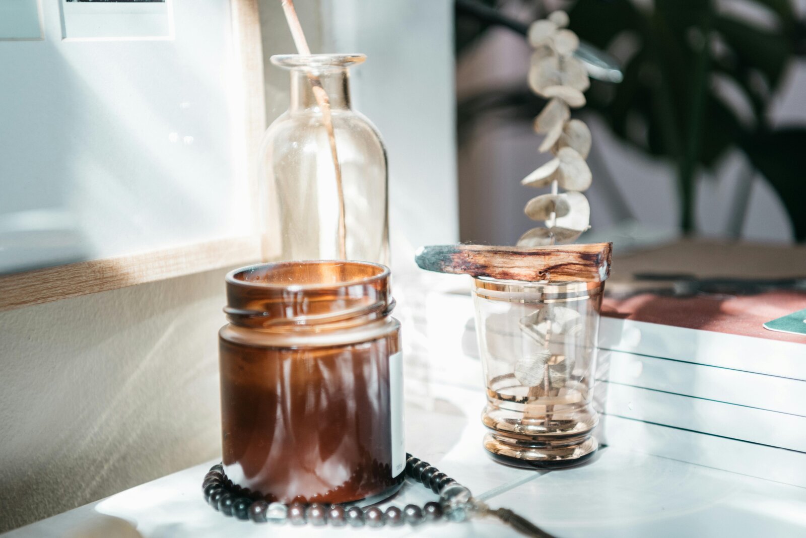 Sun-washed tabletop with eucalyptus and meditation beads